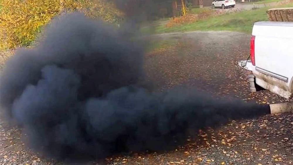 Car engine smoking black smoke from the exhaust.