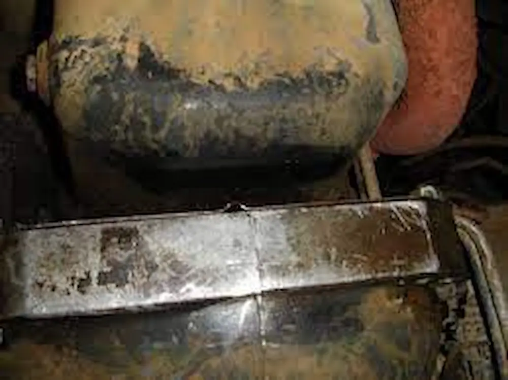 Engine oil leaks between engine and transmission.