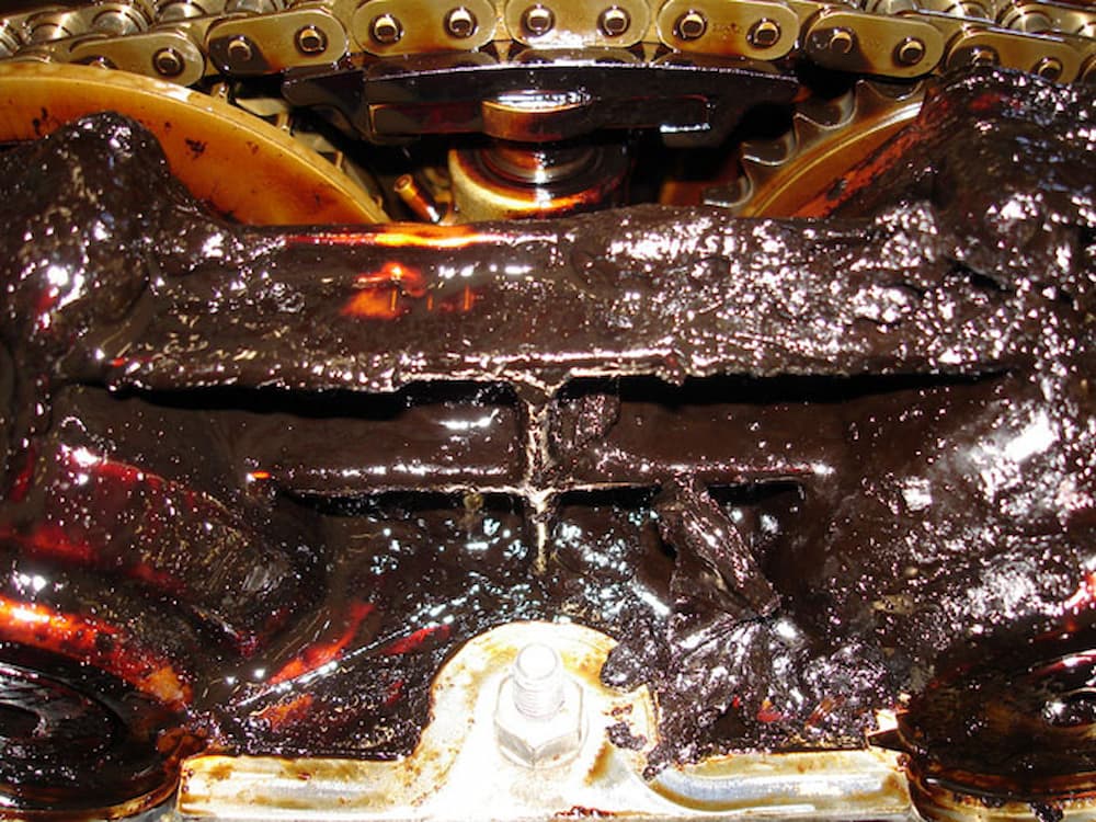 Engine oil won't drain — sludge formation.