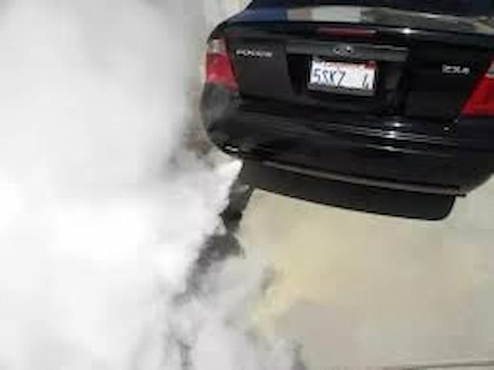 Car smoking white smoke from the exhaust.
